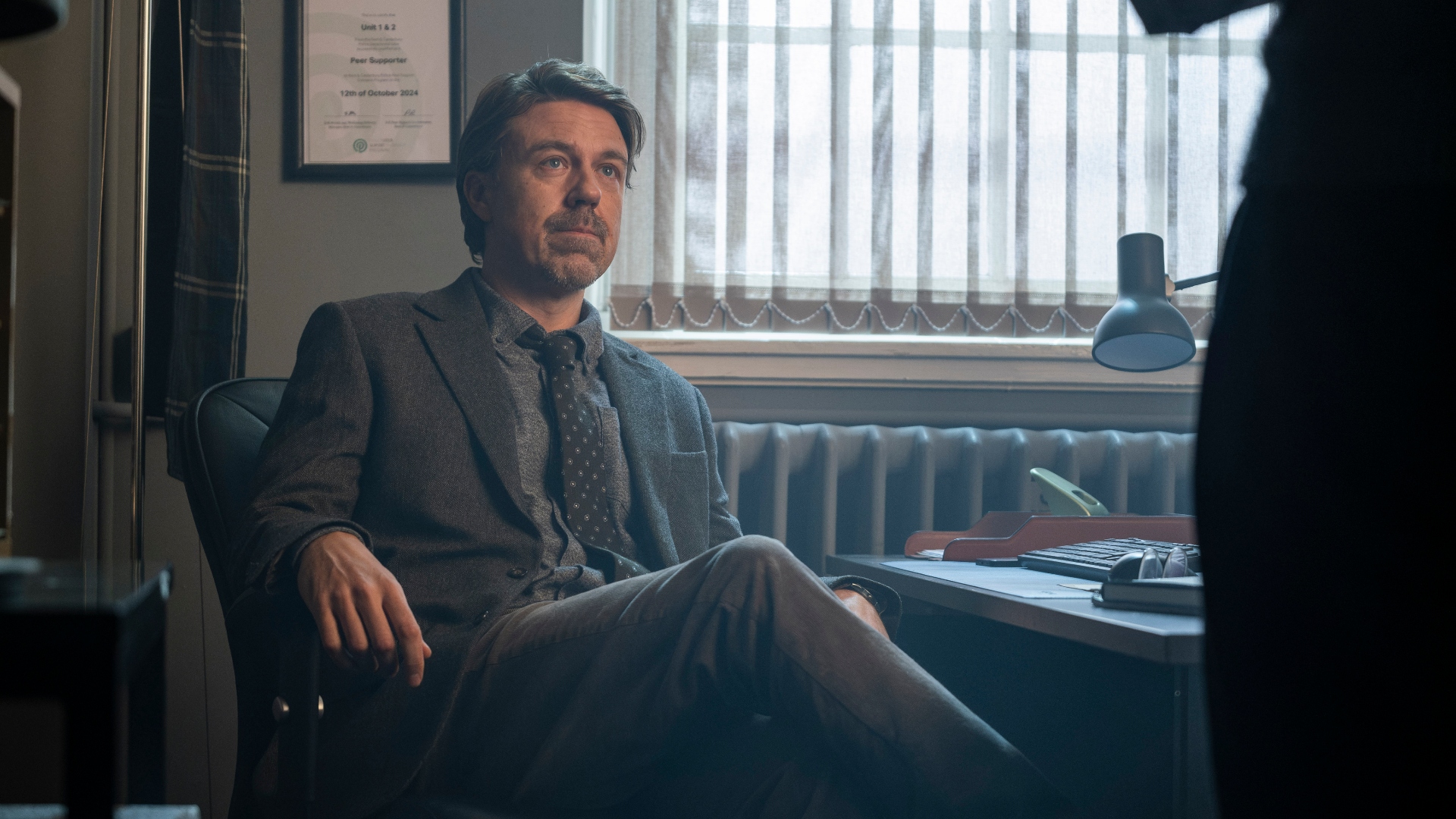 James sits in his chair in Code of Silence