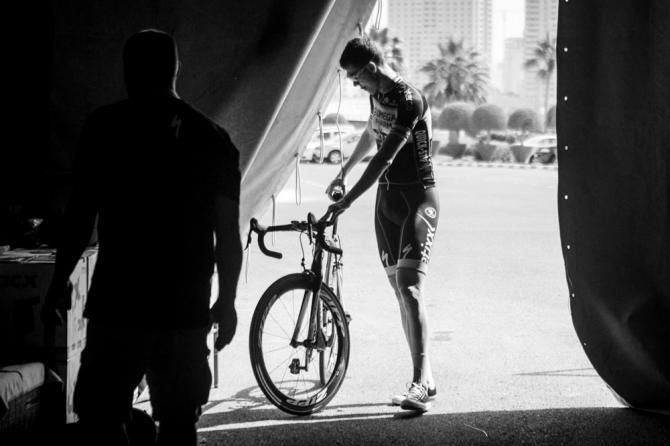 A rider heads back into the team tents in Qatar.