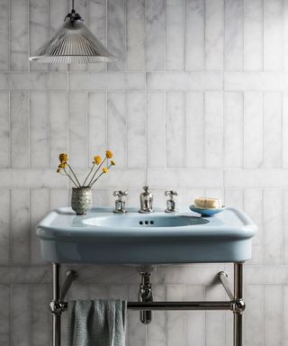 blue sink with marble tiles