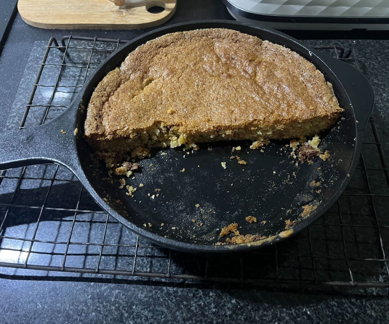 Half a skillet cookie in a mini cast iron skillet.
