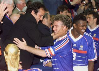 Francee captain Didier Deschamps is embraced by Les Bleus legend Michel Platini after the side's World Cup final win over Brazil in the 1998 final at the Stade de France.