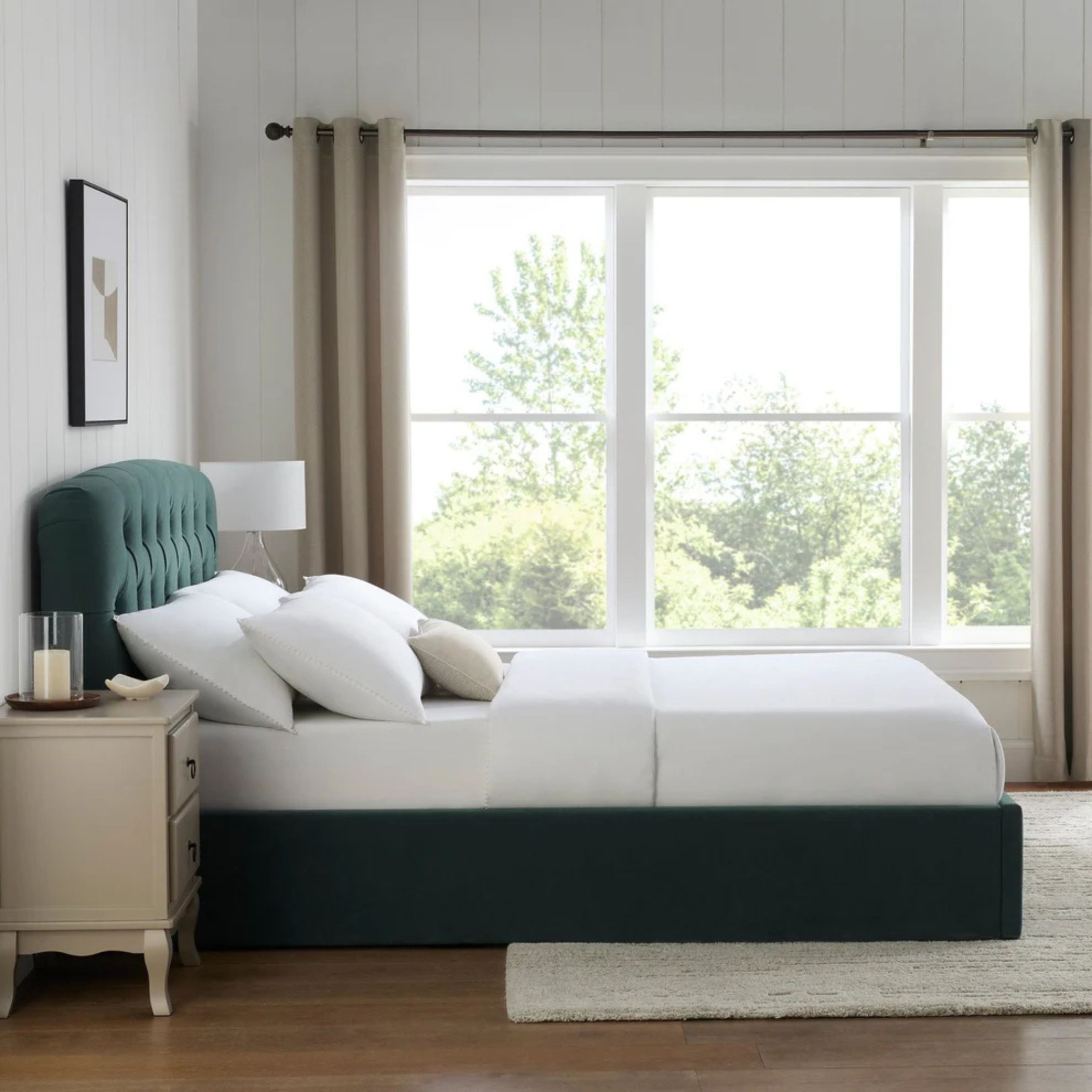 a green padded bed in a neutral bedroom