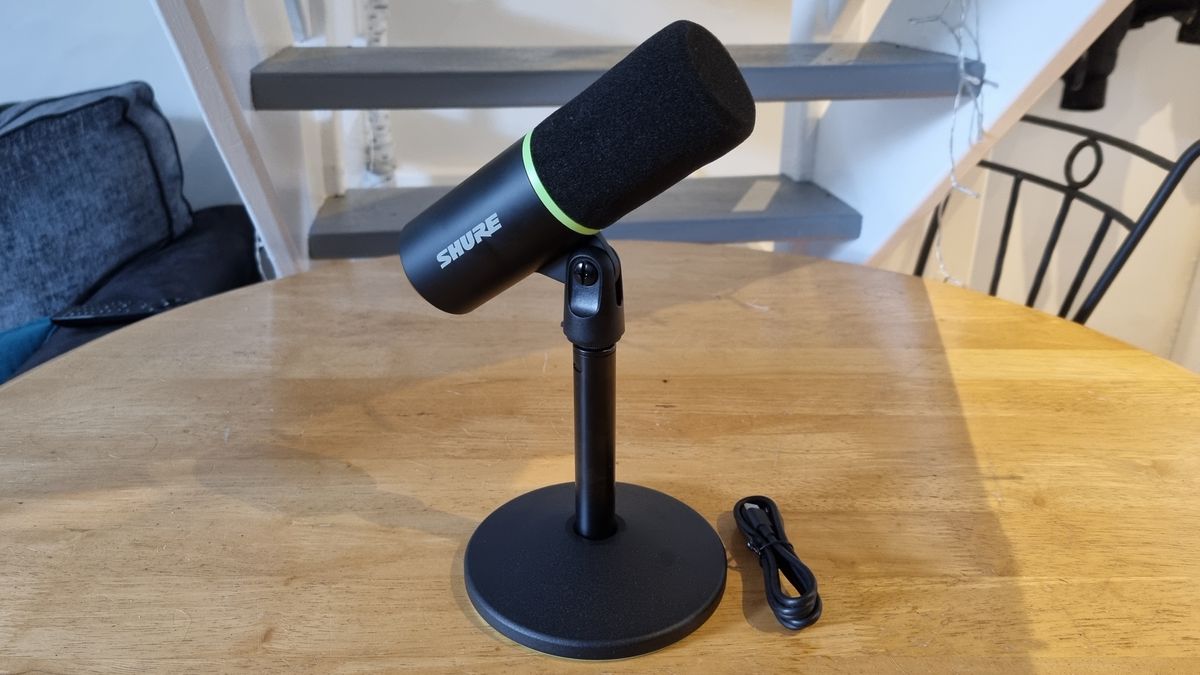 The Shure MV6 USB Gaming Microphone on a table top, with included stand and USB cable