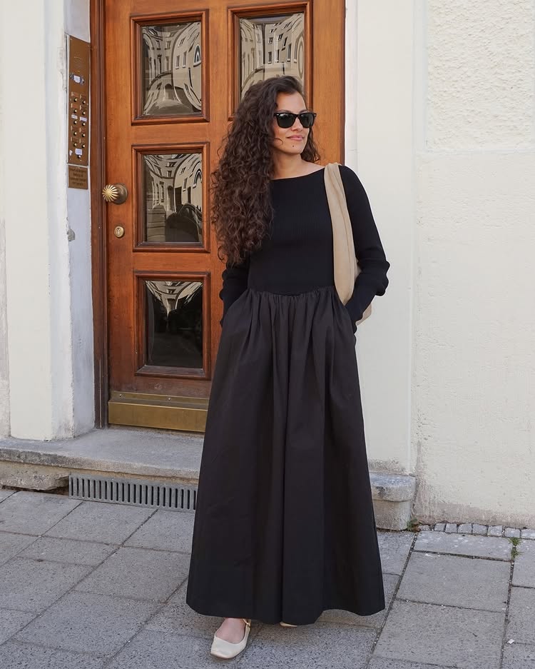 @courtney__flowers wears a black two-part dress with Mary Jane shoes and a slouchy shoulder bag