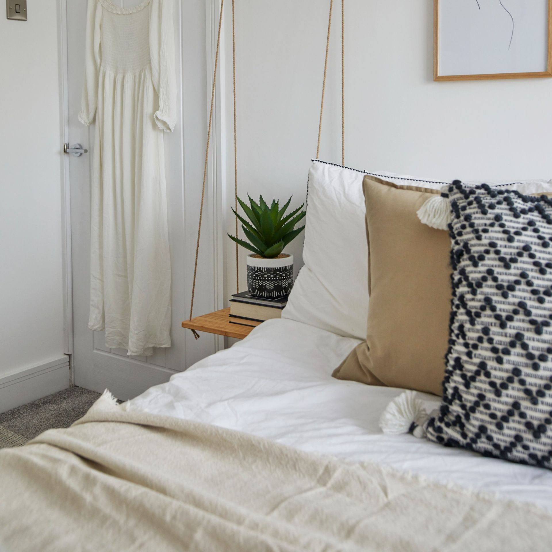white duvet cover set with beige and black cushions in bedroom