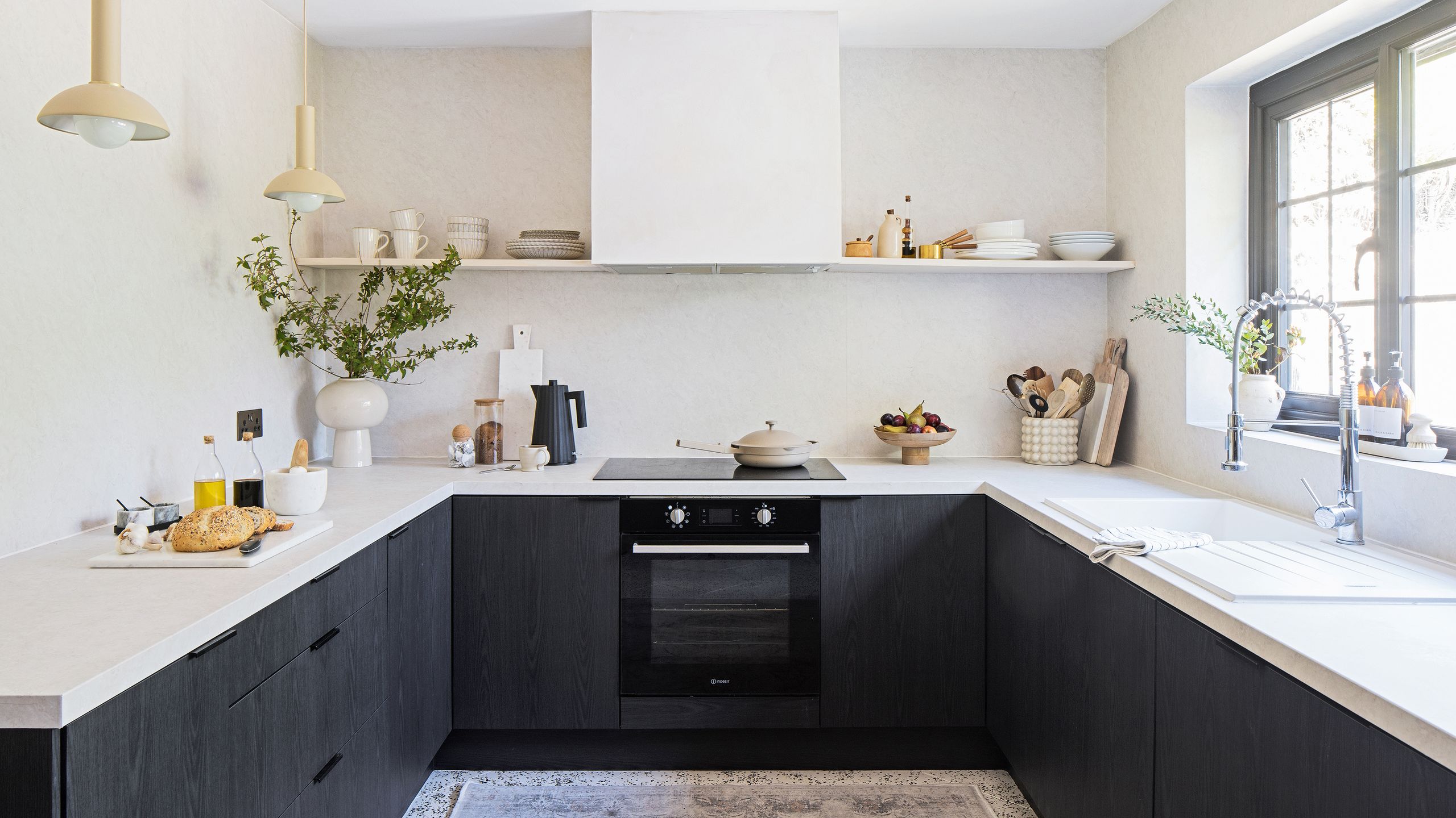 U-shaped dark grey kitchen with white worktops and no wall cabinets