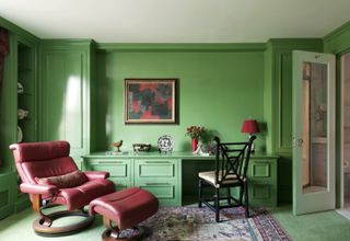A home office drenched in deep green hues