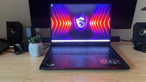 MSI Raider 18 HX gaming laptop open on a wooden gaming desk