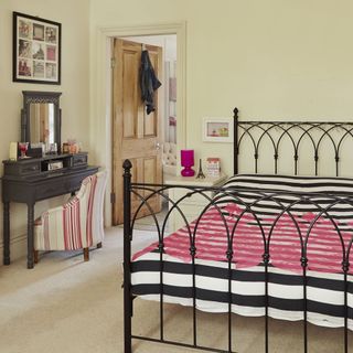 bedroom with metal cot and dressing table
