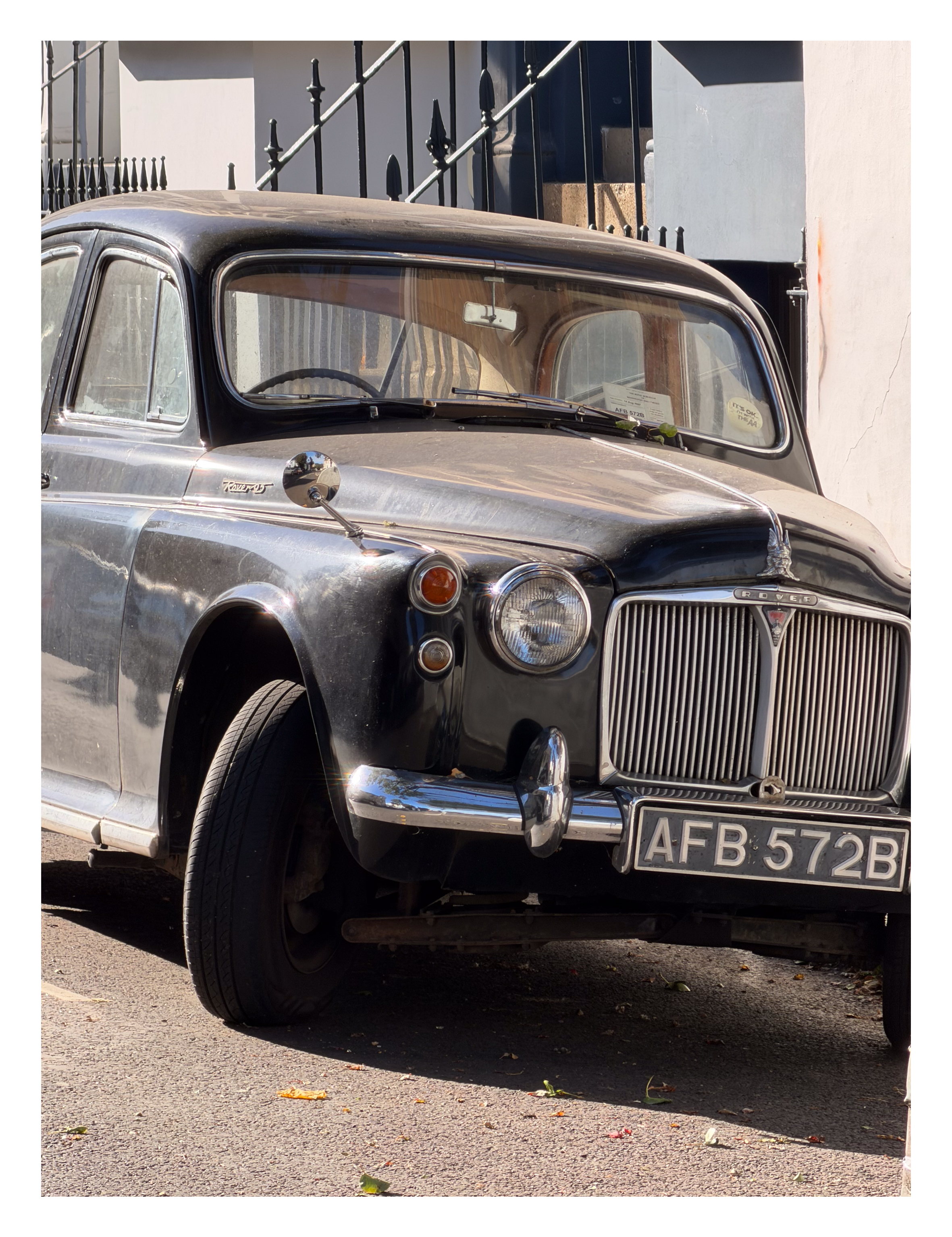 An old vintage car parked on the street