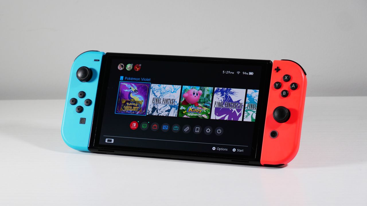 Nintendo Switch OLED on a white desk at an angle.
