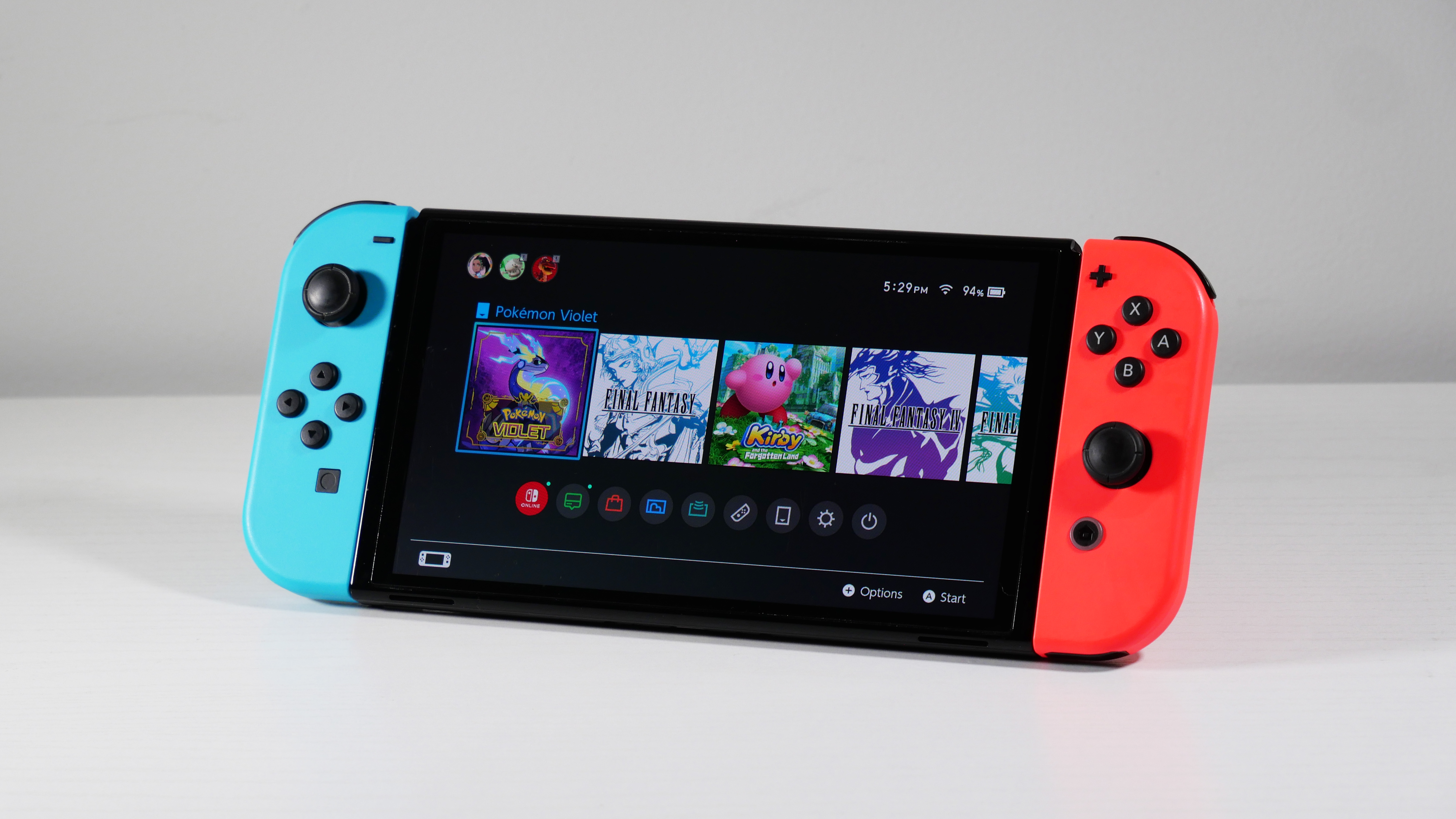 Nintendo Switch OLED on a white desk at an angle.