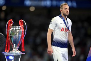 Tottenham's Harry Kane walks past the Champions League trophy