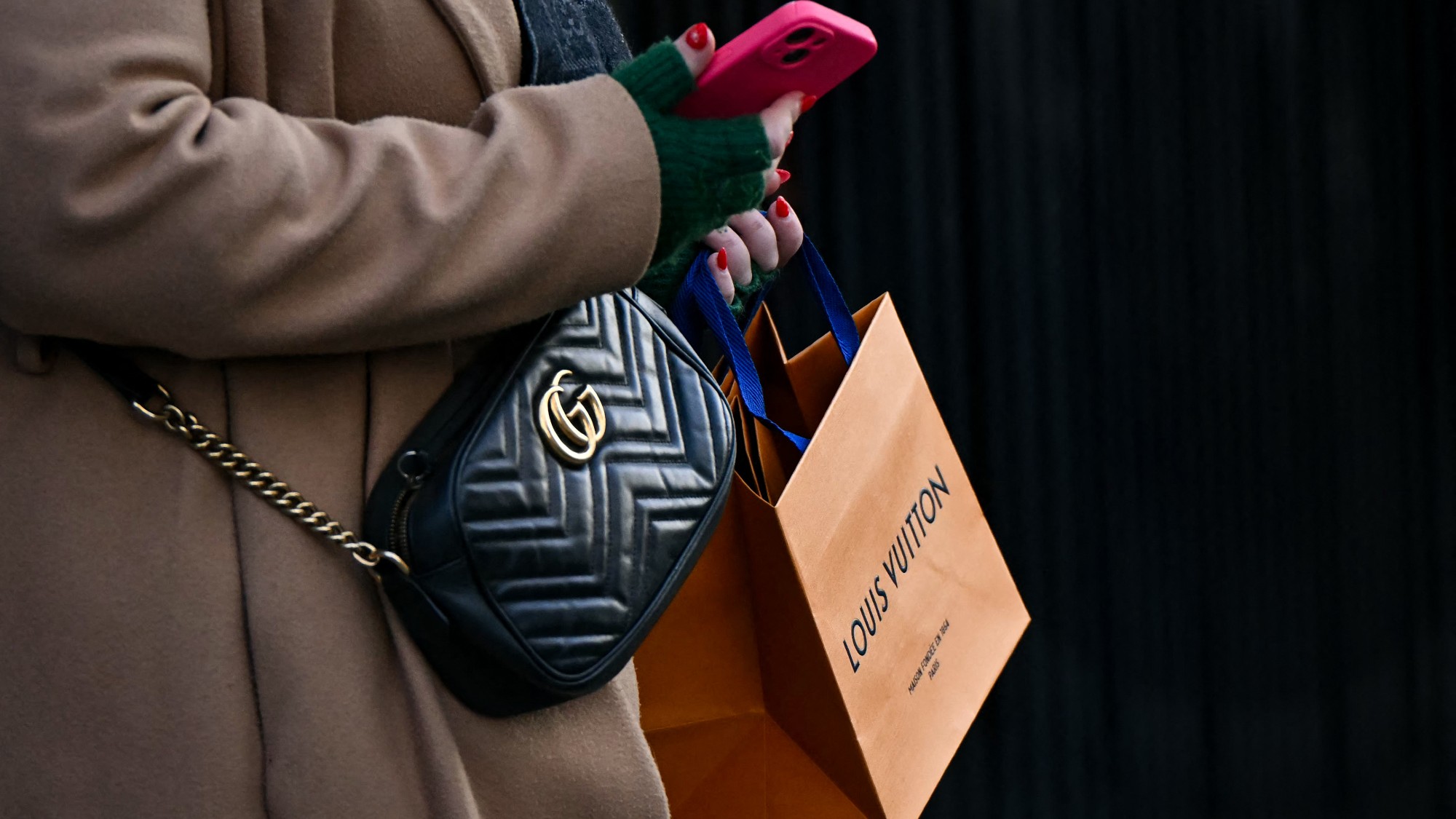 A woman carries a Louis Vuitton bag