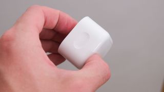 Apple 20W wall charger in a hand
