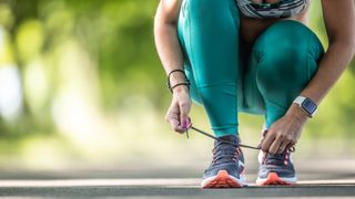 A runner tying her laces
