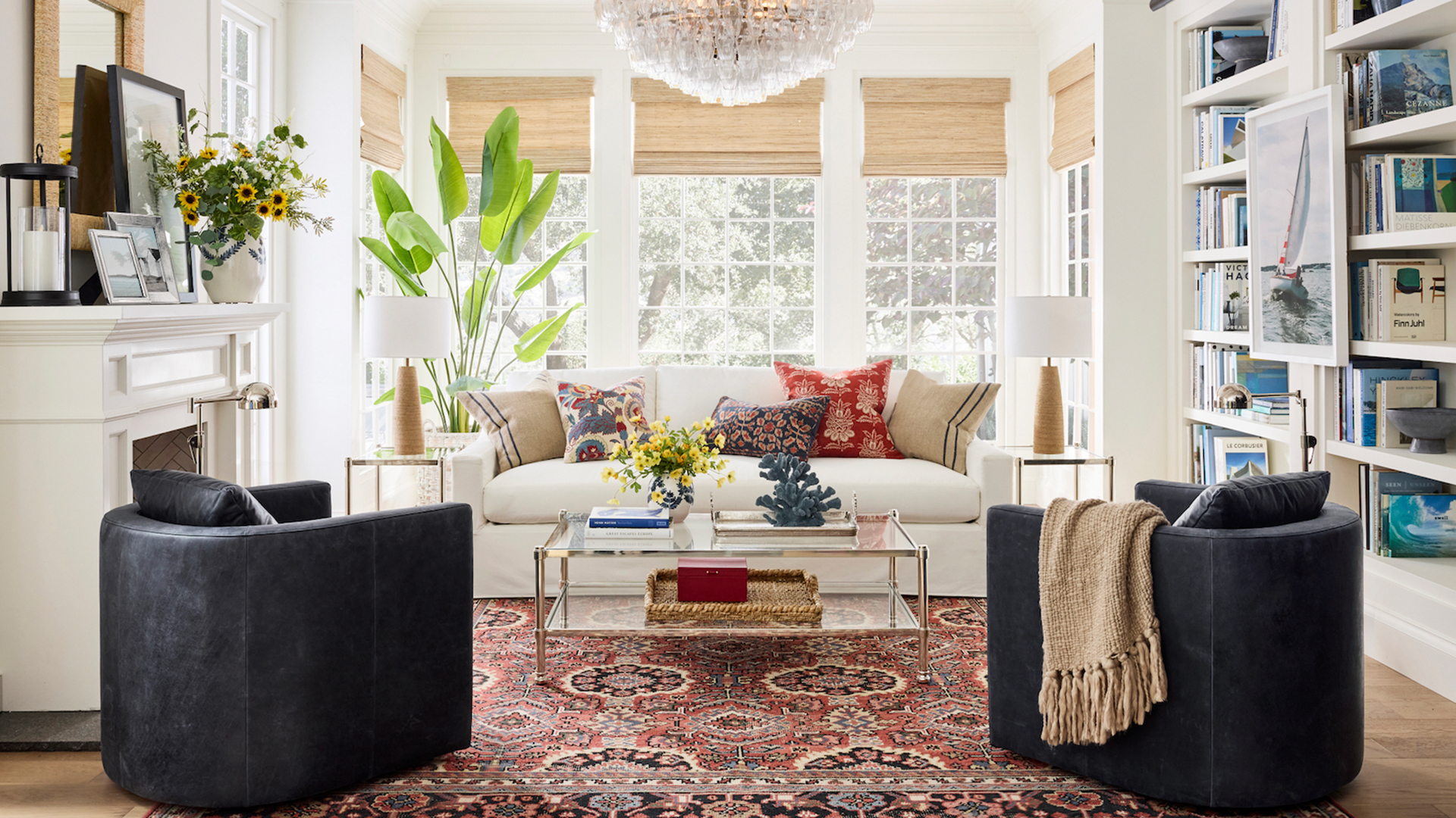 White living room styles with a Persian-style rug white sofa and navy blue curved armchairs from Pottery Barn UK