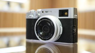 Fujifilm X100VI on a glass table front profile