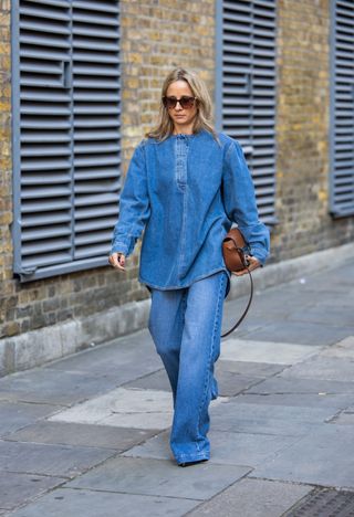 Woman in long wide-leg denim jeans and denim top.