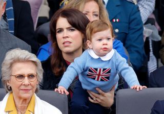 Princess Eugenie holding her son August in a crowd