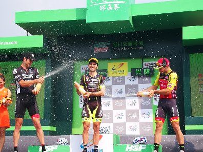 The podium finishers spray the champagne after the first stage of the Tour of Hainan