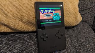 Analogue Pocket review; a small handheld on a sofa