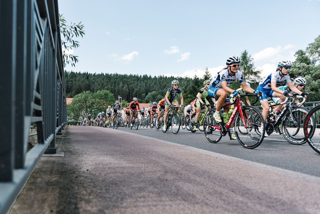 Peloton speeds over a bridge