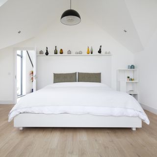 bedroom with white walls and wooden flooring