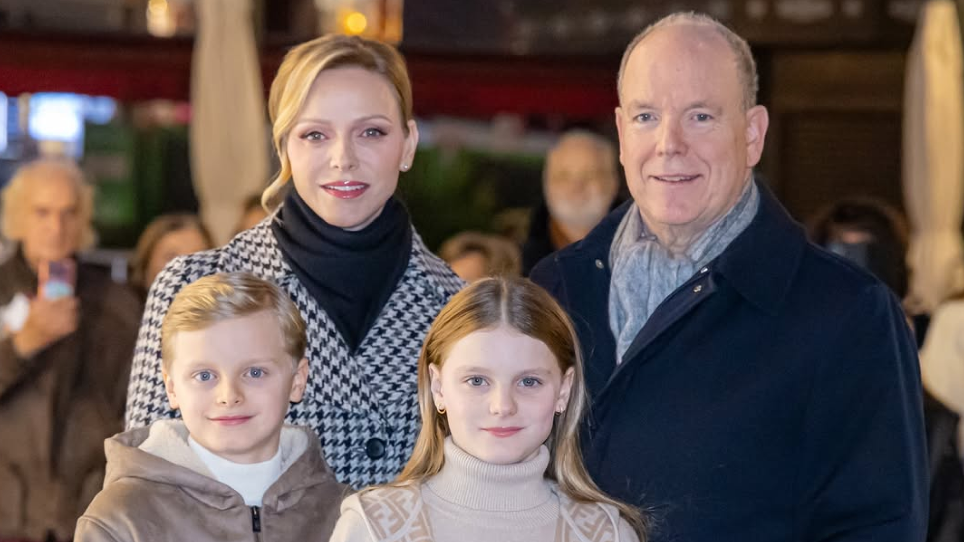 Princess Charlene, Prince Albert, Prince Jacques and Princess Gabriella posing in coats and scarves