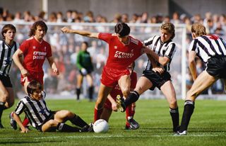 Liverpool defender Alan Hansen (centre) is challenged by Newcastle United's Paul Gascoigne in a game in August 1985.