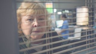 Jan (Diane Botcher) looks through a window in Casualty