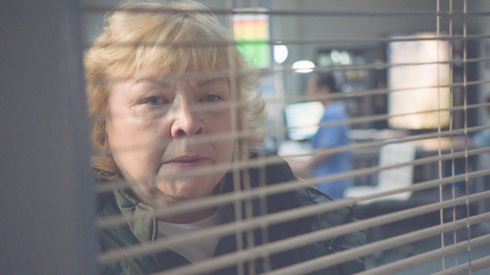 Jan (Diane Botcher) looks through a window in Casualty