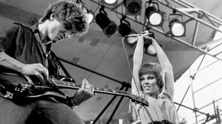 American Rock musicians Neil Giraldo, on electric guitar, and singer Pat Benatar perform onstage during the Dr Pepper Summer Music Festival in Central Park, New York, New York, July 25, 1980.