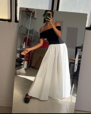 @bellathomas wearing a white maxi skirt with black top