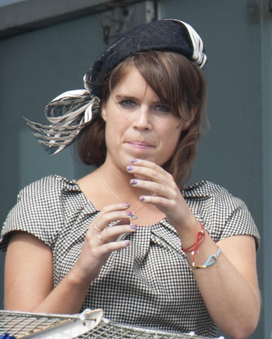 Princess Eugenie at the 2012 Epsom Derby wearing a checkered dress and black hat