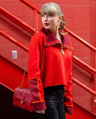 Taylor Swift walks into Arrowhead Stadium before a football game wearing her favorite red lipstick by pat mcgrath