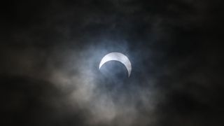 A partial solar eclipse viewed through the clouds in Winnemucca, Nevada, United States on October 14, 2023.