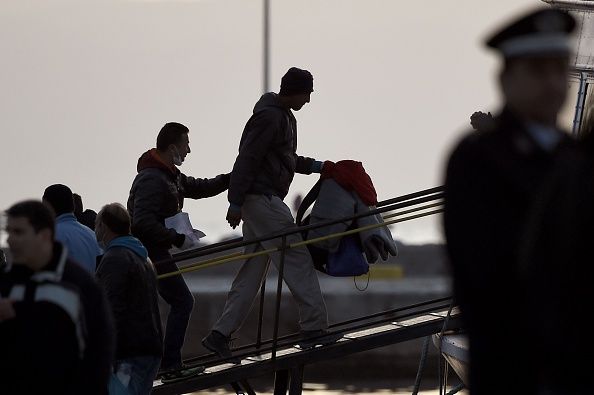 Migrants board a boat bound for Turkey in Greece on Monday.