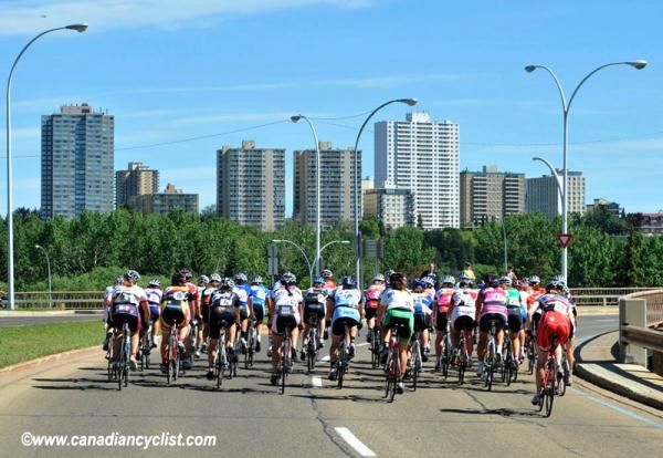 The peloton against the cityscape of Edmonton.