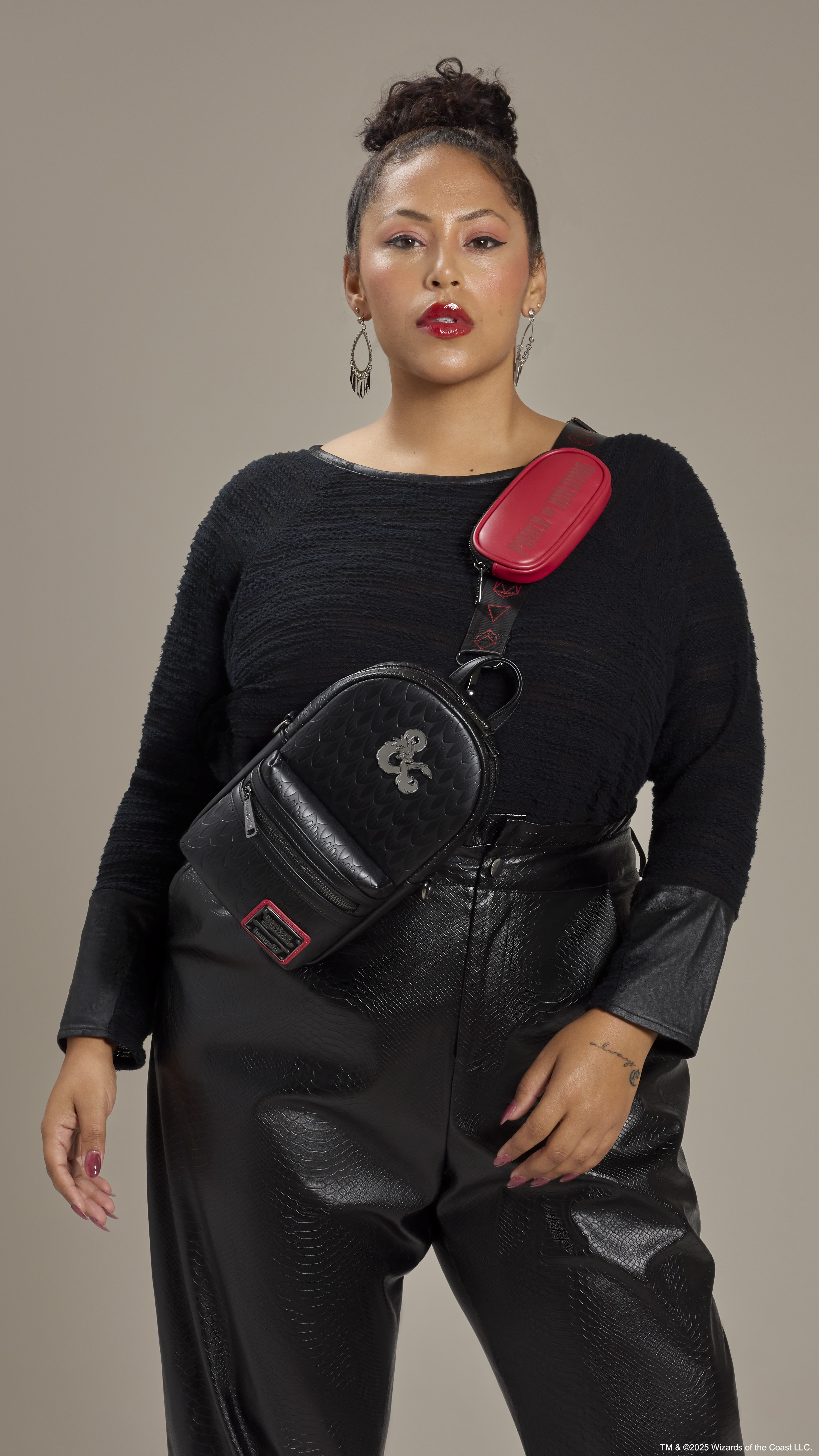 D&D Loungefly Crossbody Bag being worn by a woman dressed in black, facing the viewer