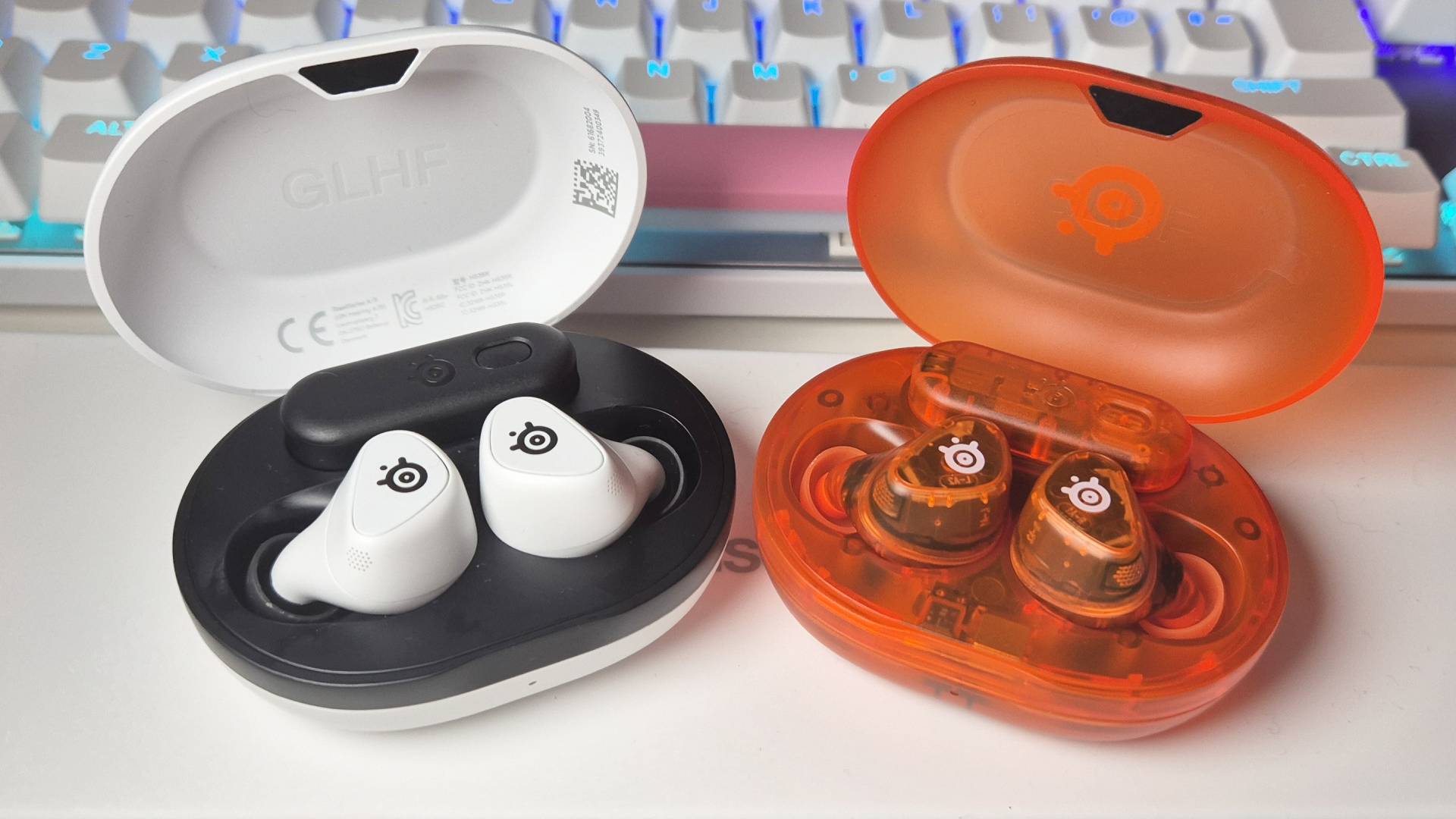 Photo of the original SteelSeries Arctis GameBuds sitting next to the Glorange GameBuds, taken by writer Rosalie Newcombe.