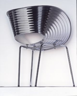 Tom Vac, 1997. A shiny metallic curved backed chair with thin legs.