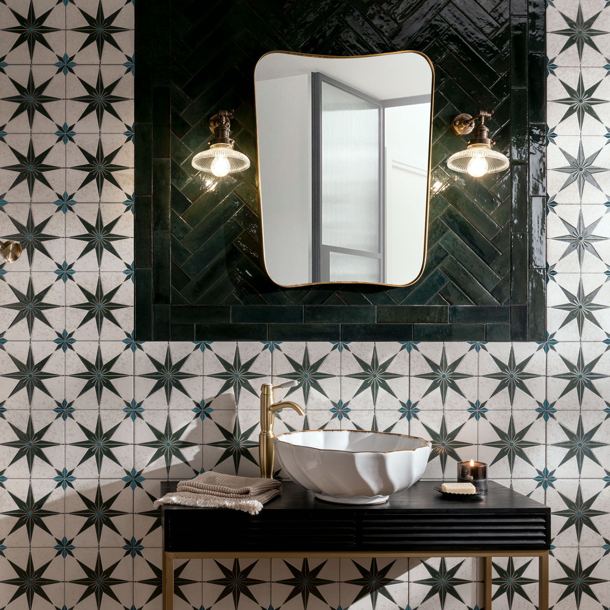 Tiles with a star pattern on and brik tiles in a herringbone pattern around a mirror