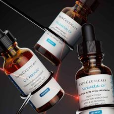 Three skinceuticals dropper bottles in front of a black background with red lasers. 
