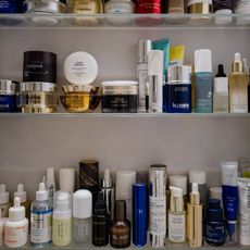 Photo of many skincare products on a bathroom shelf 