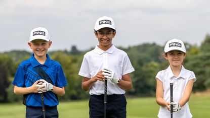 Children sporting PING hats and holding clubs to launch the Junior Golf Tour