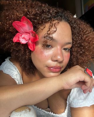 Content creator Ana Rivera with curly copper hair