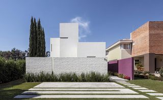 White building with trees in garden