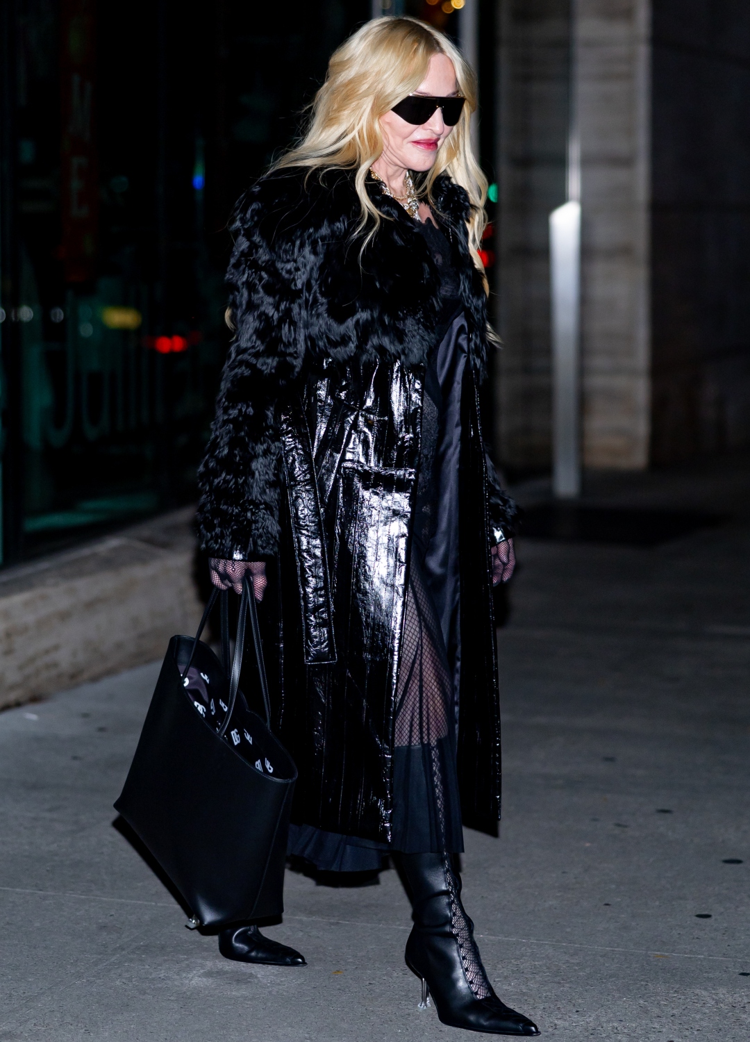 Madonna wearing black trench coat