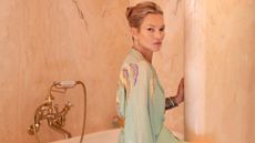 Kate Moss sits in her luxury bathroom that is drenched in pink marble
